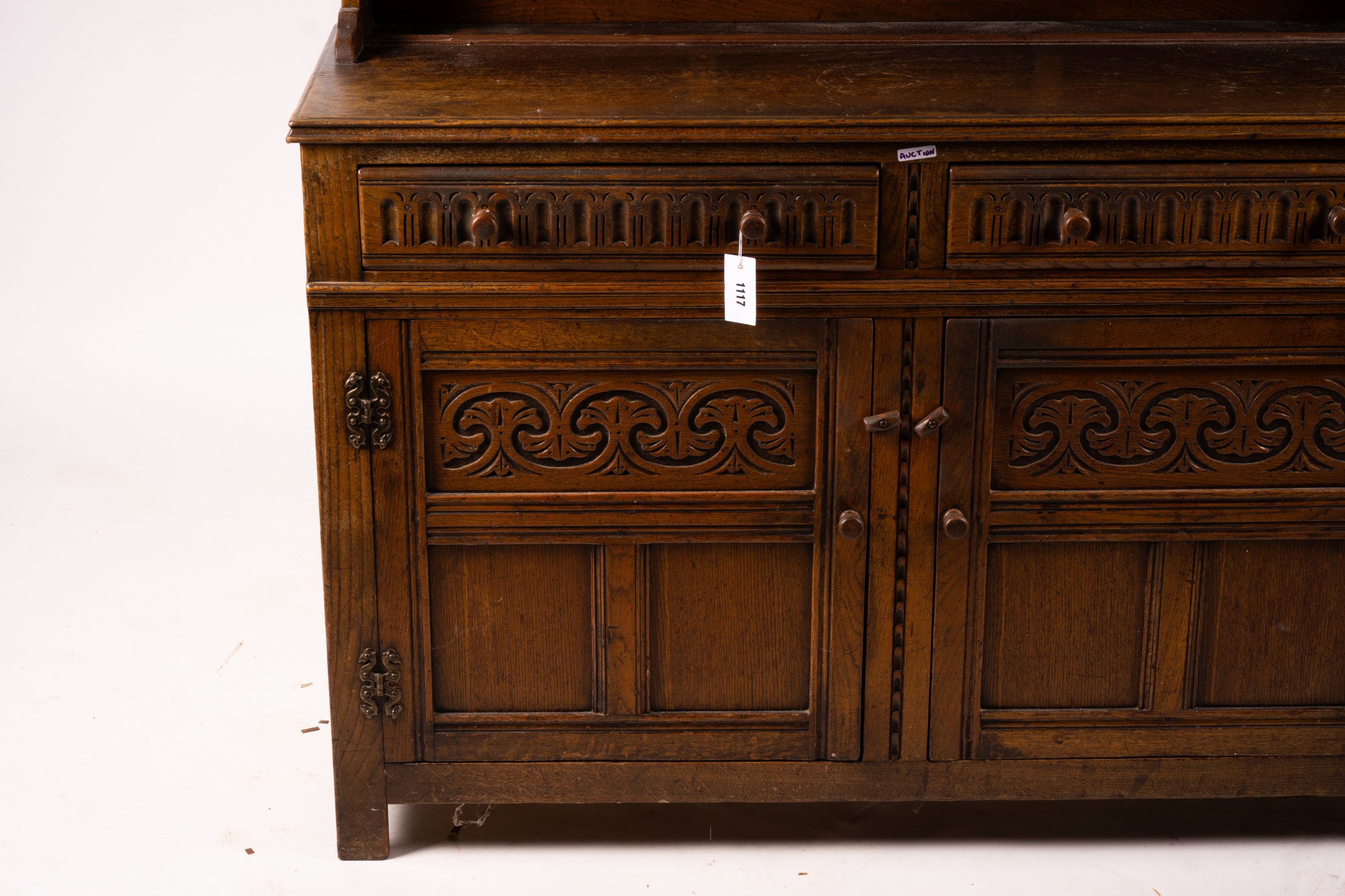 An 18th century style carved oak dresser, width 124cm, depth 46cm, height 175cm